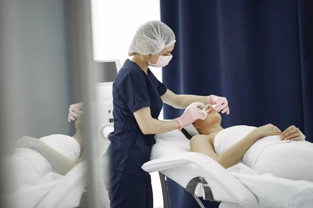 A dermatologist performing a professional skin treatment on a woman for skin problems that need expert care
